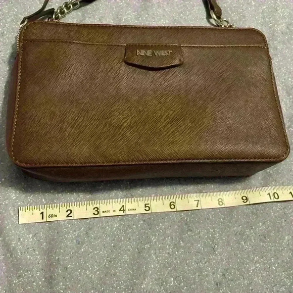 Nine West Crossbody brown with silver hardware. Snap closure and zipper pockets. - Picture 5 of 11